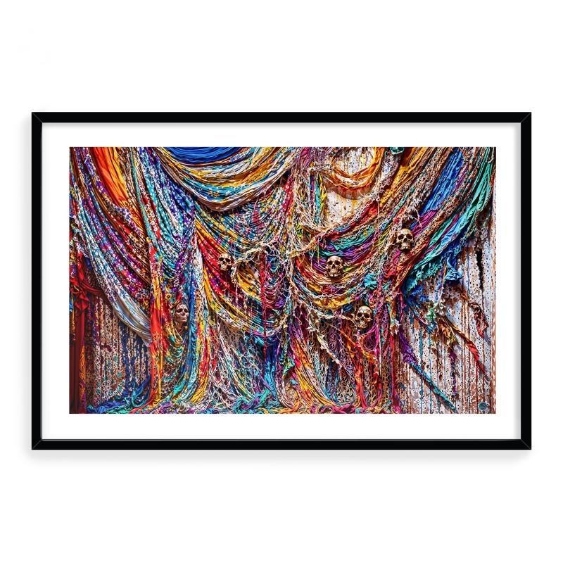 Colorful woven fabric with skulls hidden among tangled threads, symbolizing forgotten stories and memories.